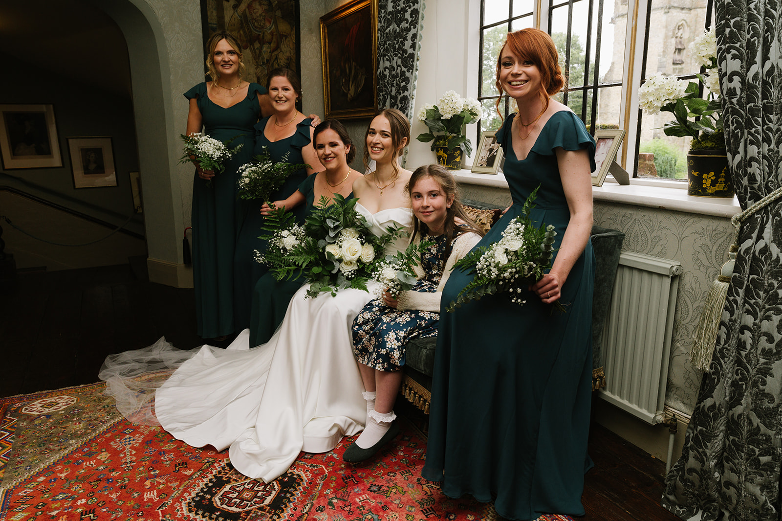The bride and bridesmaids in the hallway at Chenies Manor
