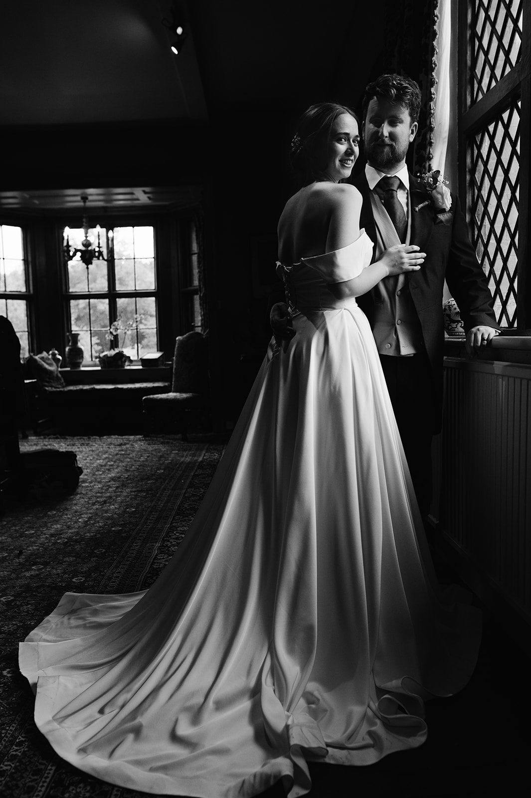 The bride and groom by the window in Chenies Manor