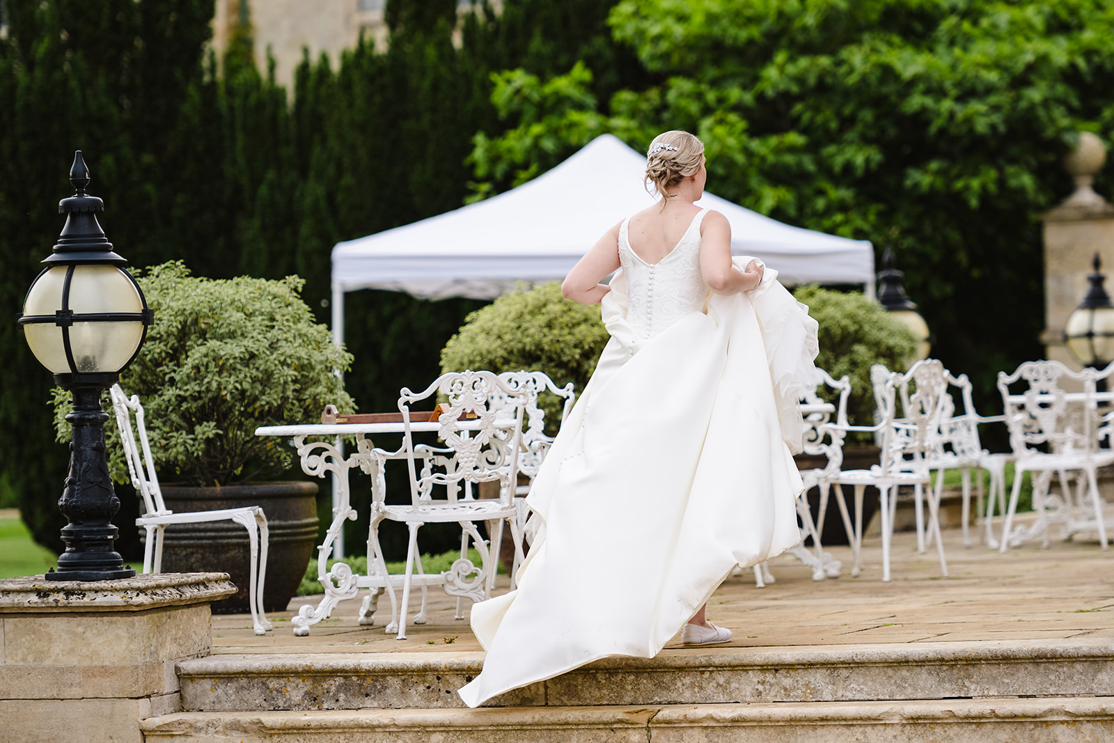 bride walking up the steps holding her dress
