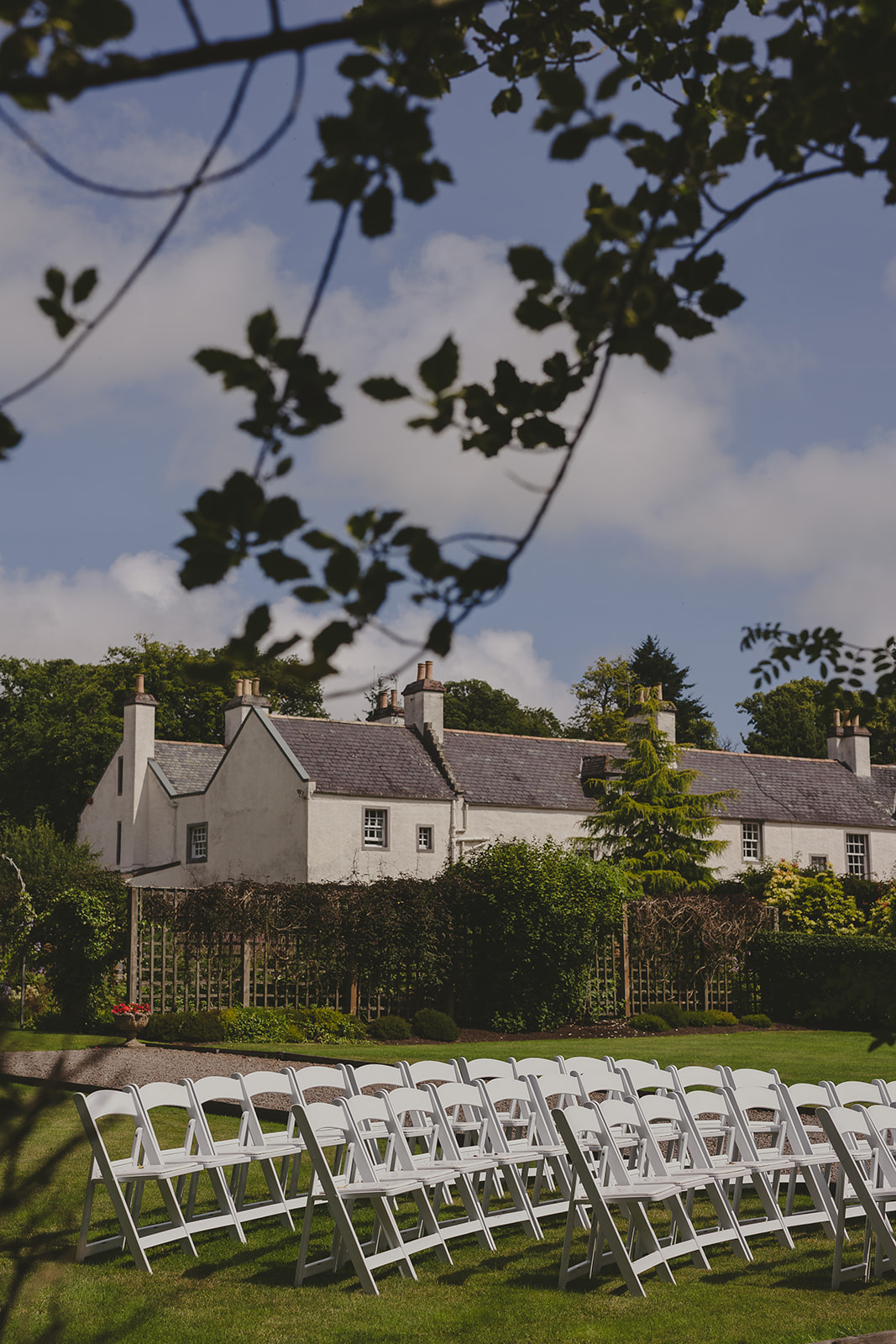 An outdoor wedding ceremony set up on the lawn of Elsick House in Aberdeenshire on a beautiful Scottish Summer day.