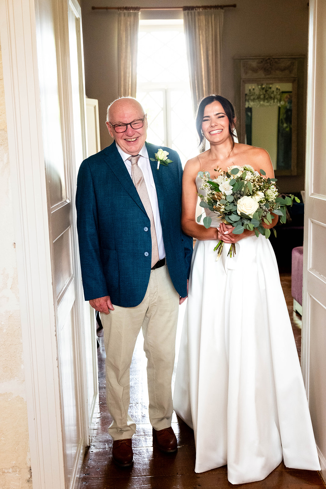 happy Bride with her Dad ready to set off down the aisle