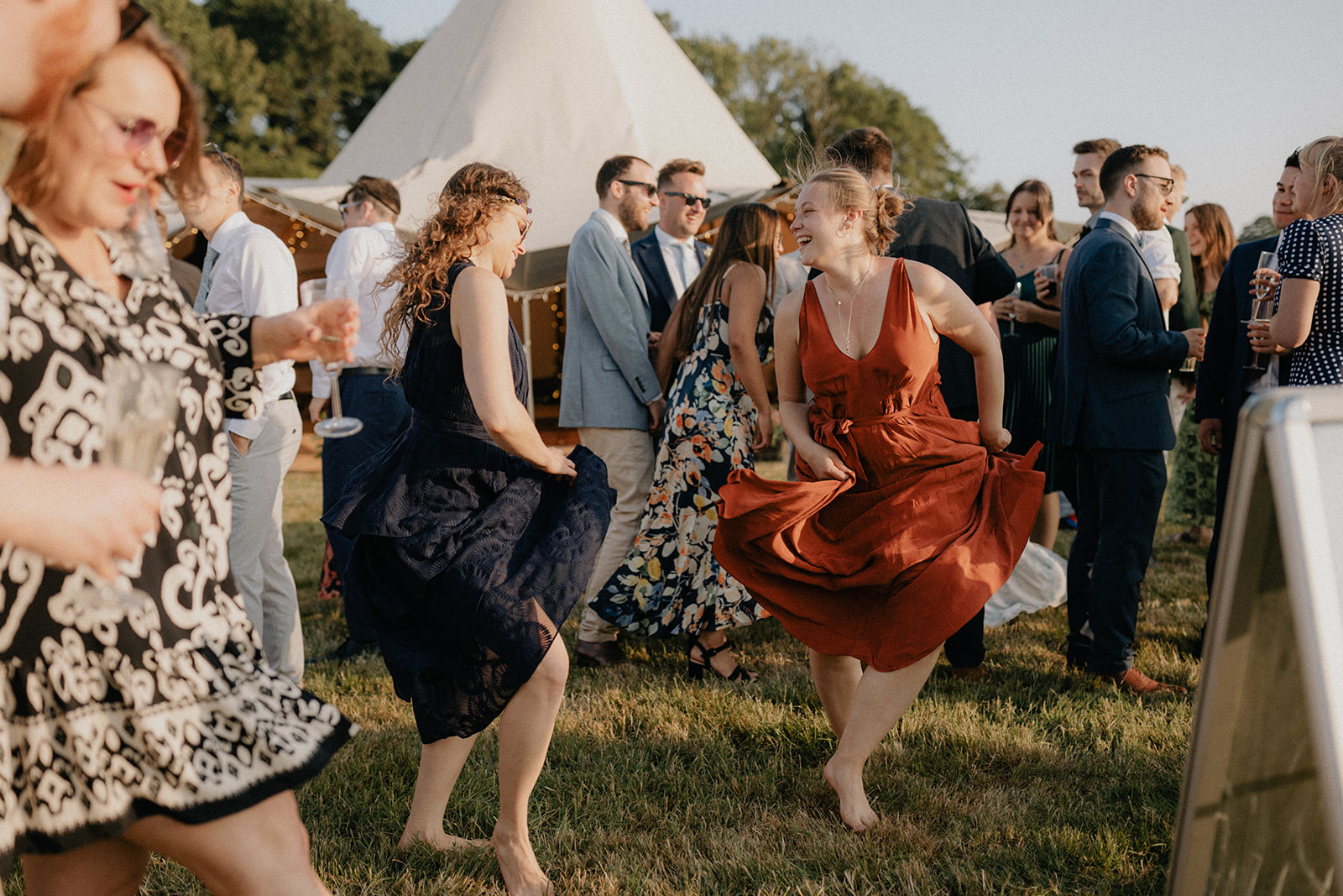 guests dancing outside during sunset at a wedding
