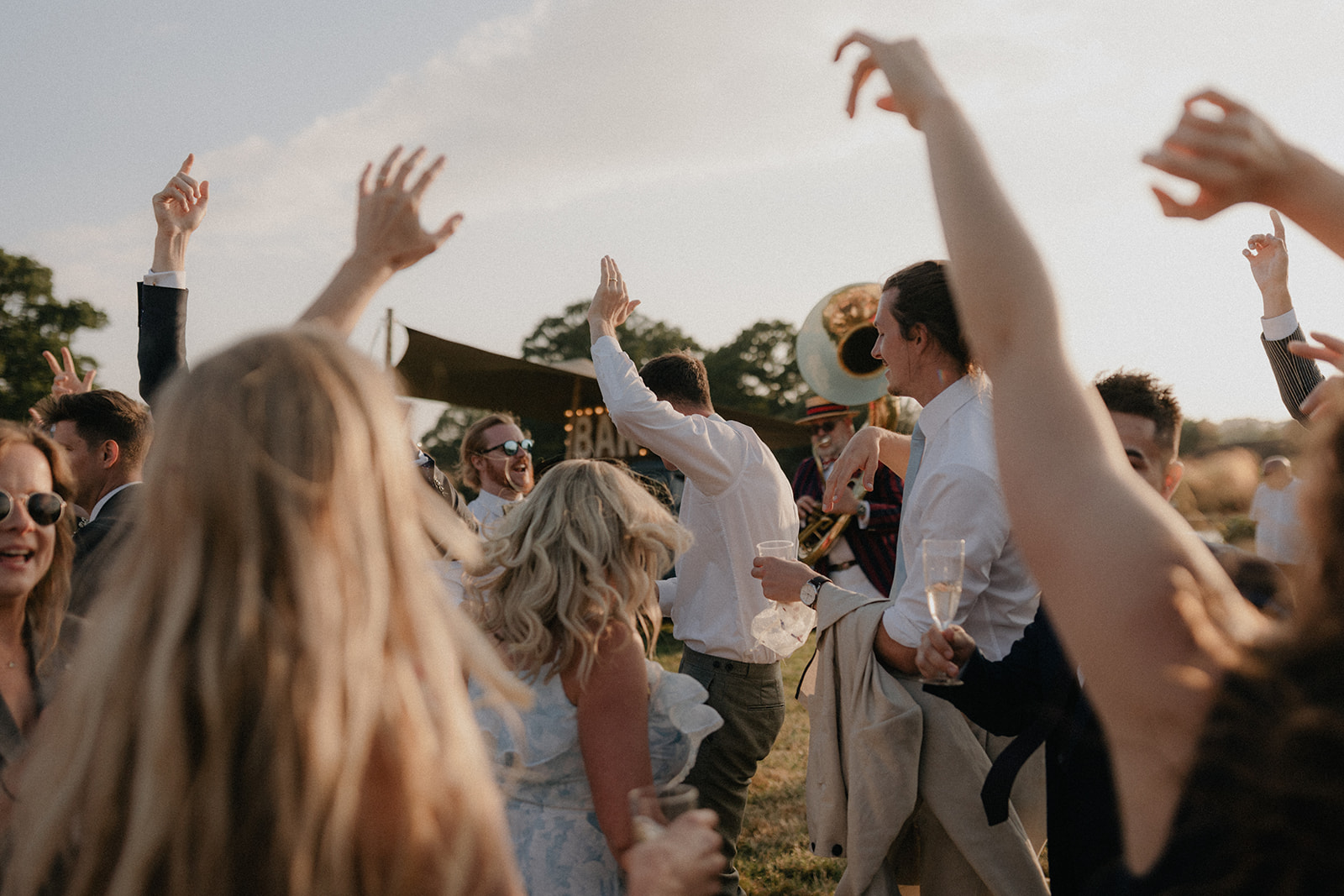 guests dancing outside during sunset at a wedding