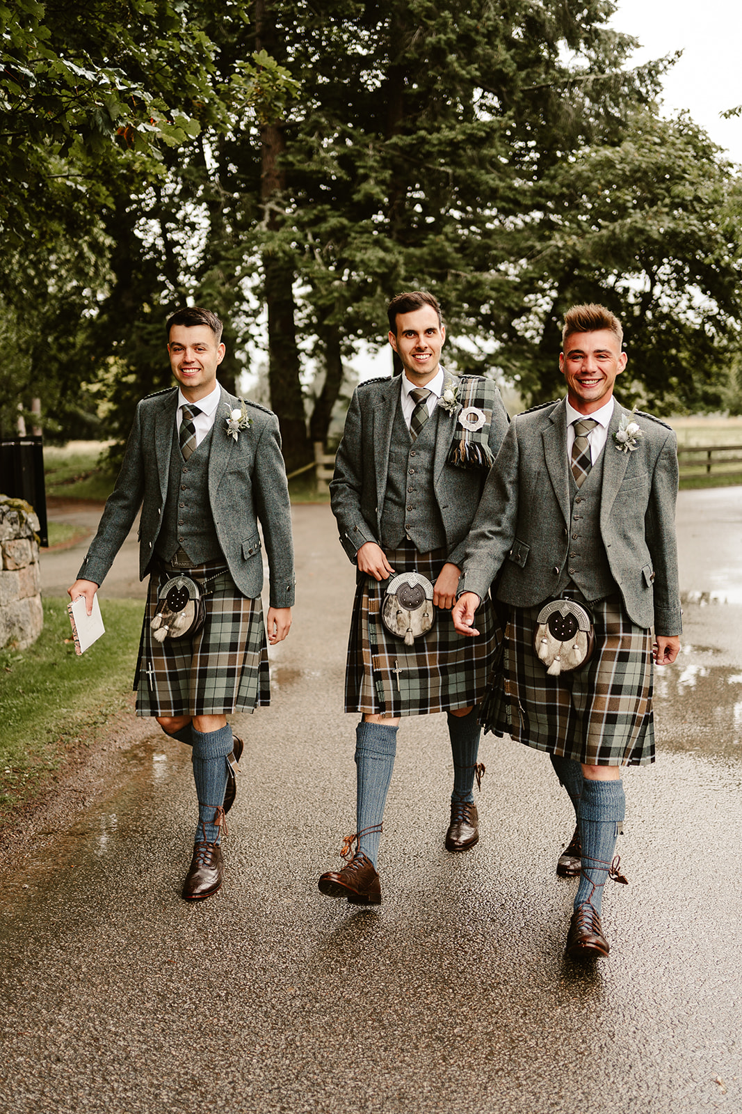 Image of three groomsman walking outside of The Coos Cathedral
