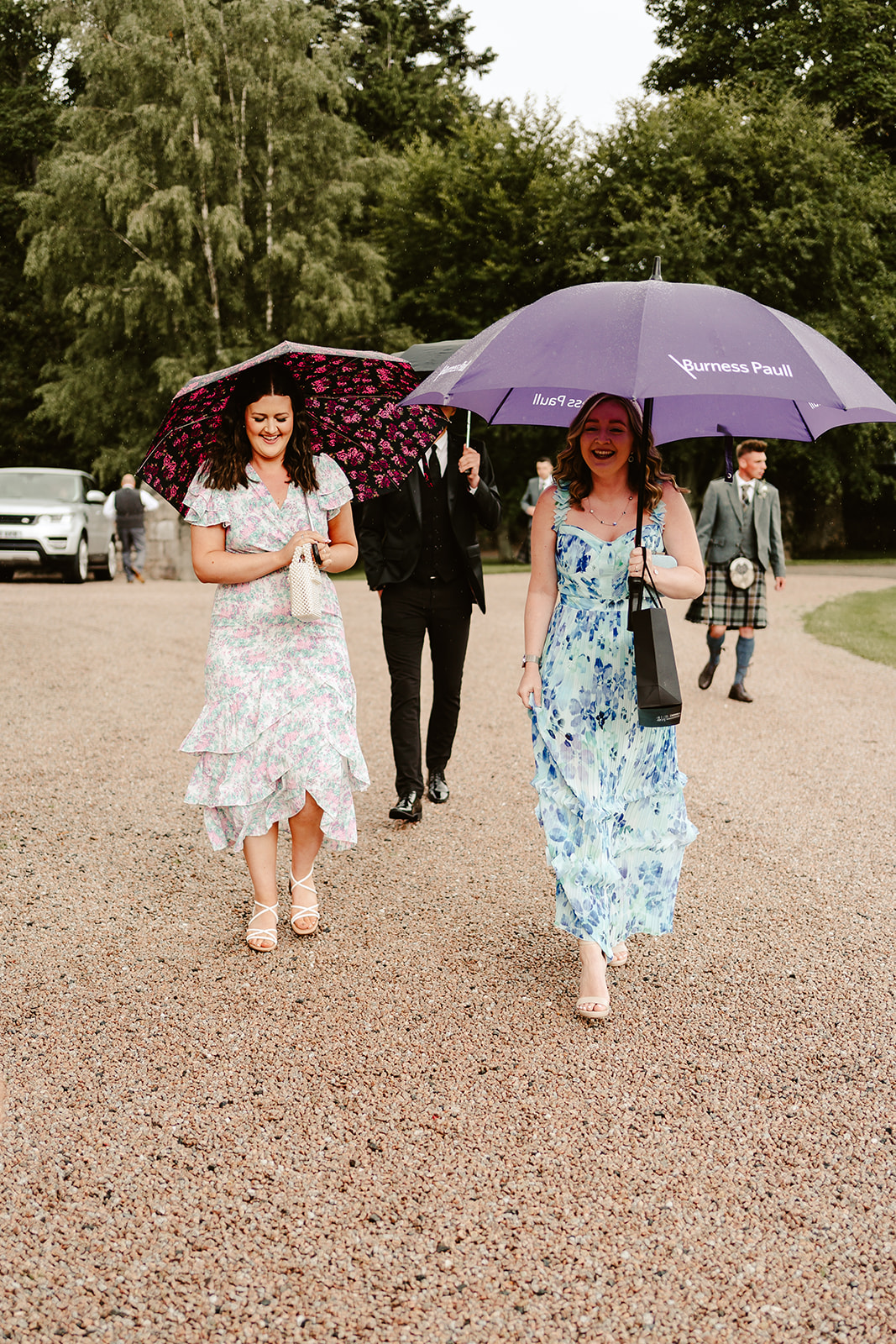 Image of wedding guests with umbrellas 
