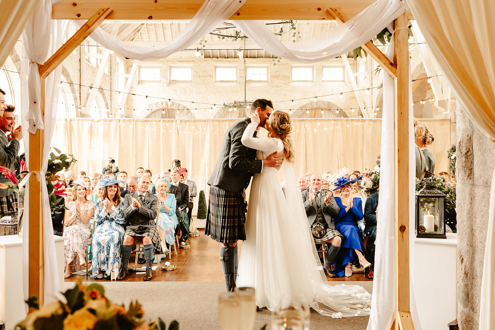Image of a bride and groom sharing their first kiss at The Coos Cathedral
