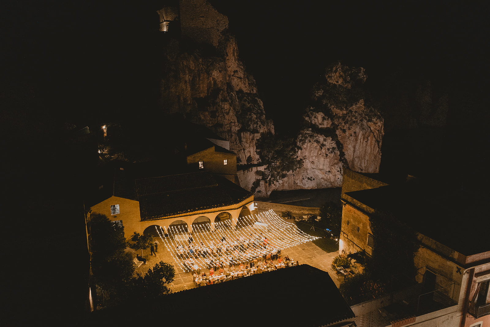 Aerial photo of the Tonnara di Scopello at night during a wedding