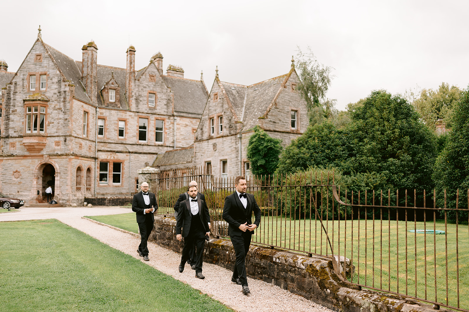 groom and groomsmen walking outside castle leslie estate