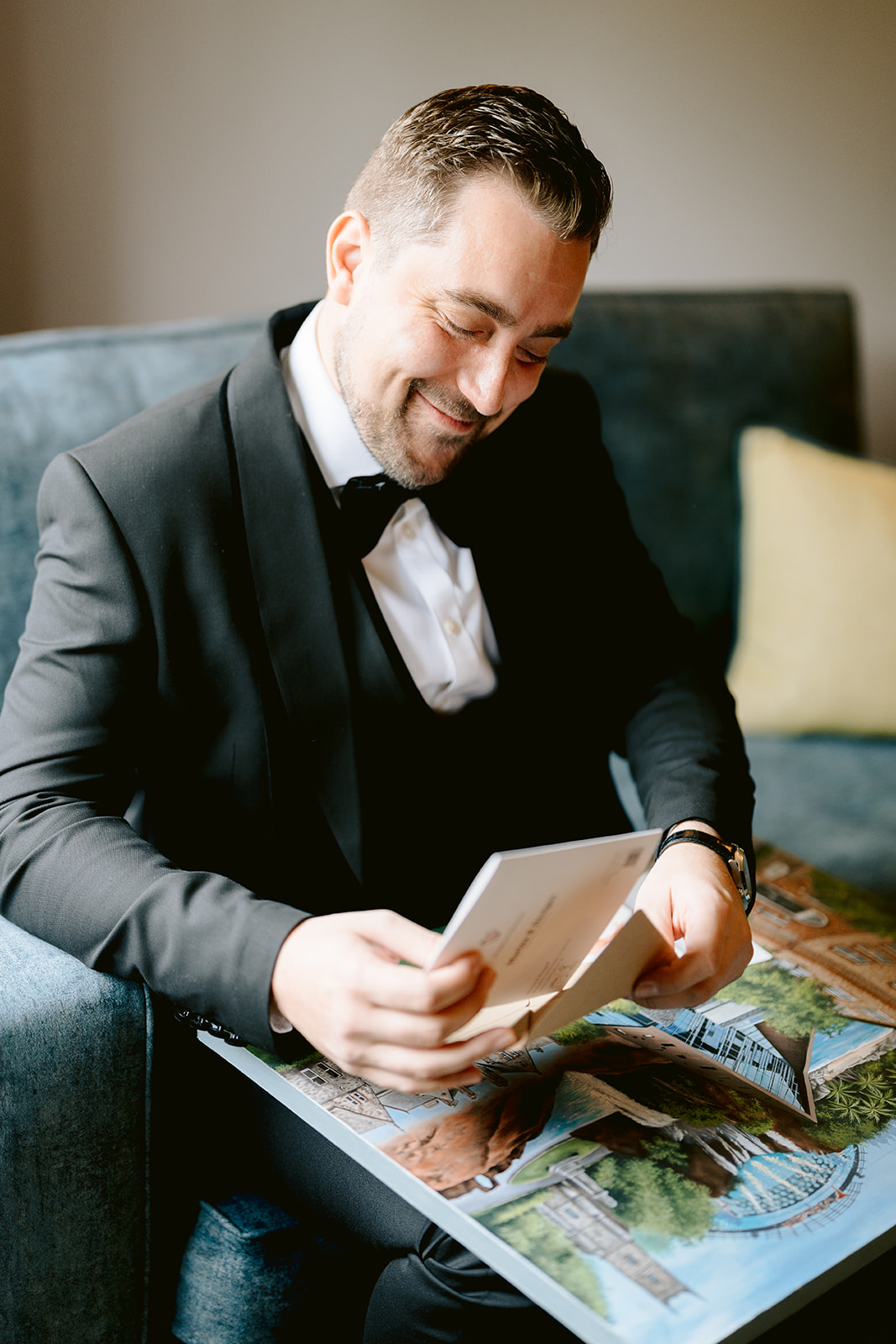 groom opening a wedding gift from the bride