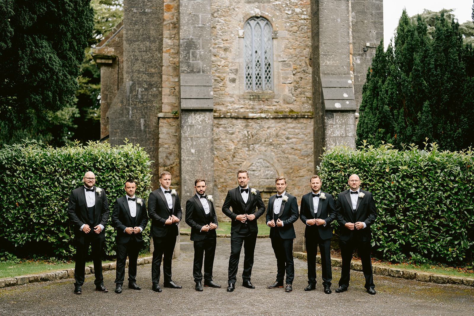 groosmen portraits before the wedding outside the church at castle leslie