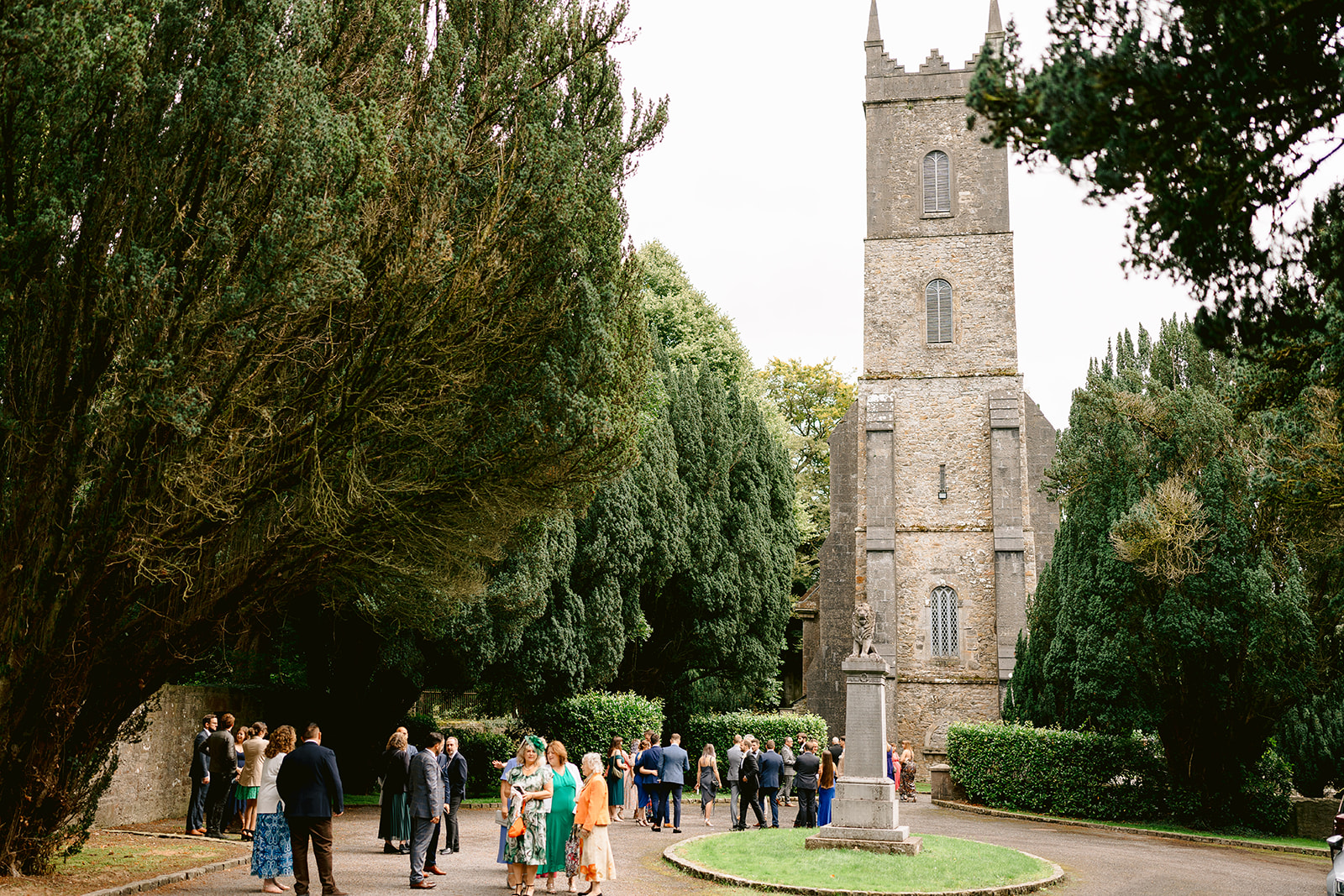 wedding guests walking towards the castle leslie church