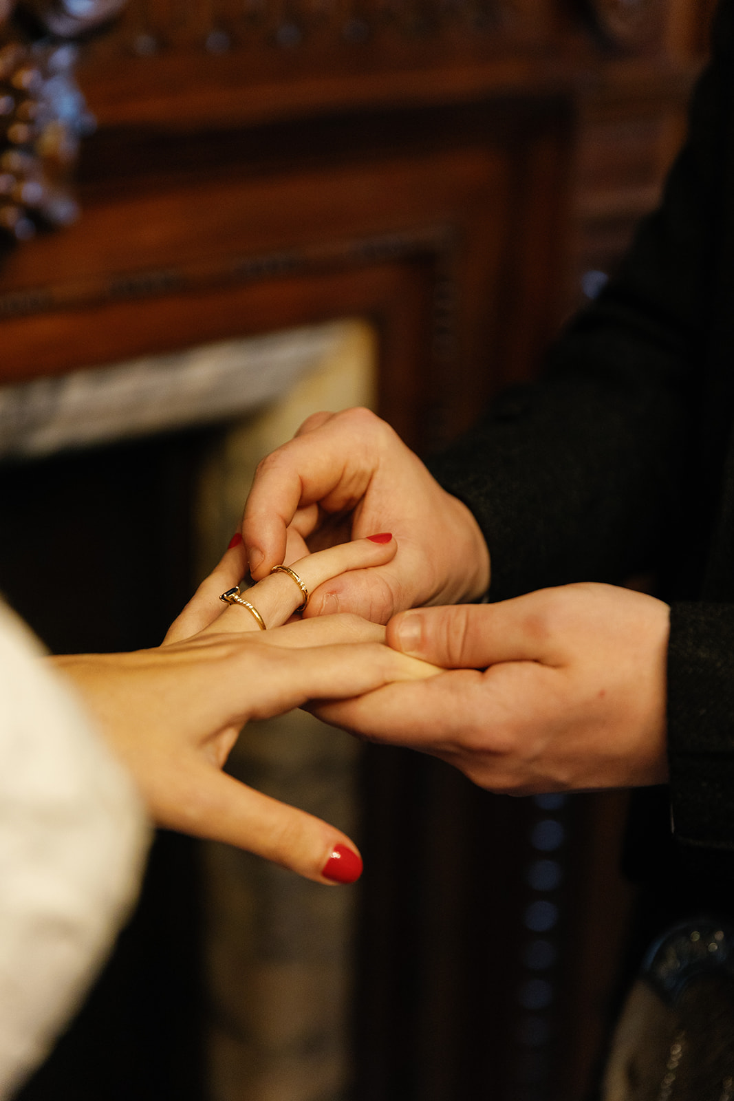groom putting the ring on the bride's finger