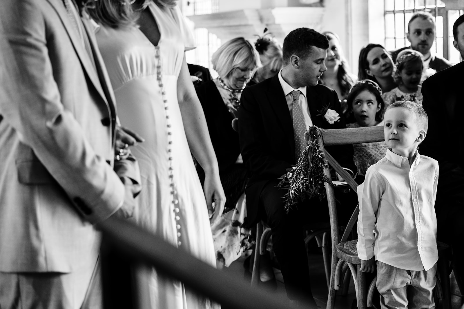 Boy looking on as his parents get married at Normanton Church