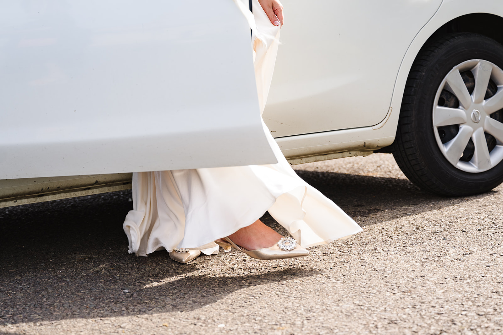 close up of brides feet stepping out of the car at normanton church in rutland