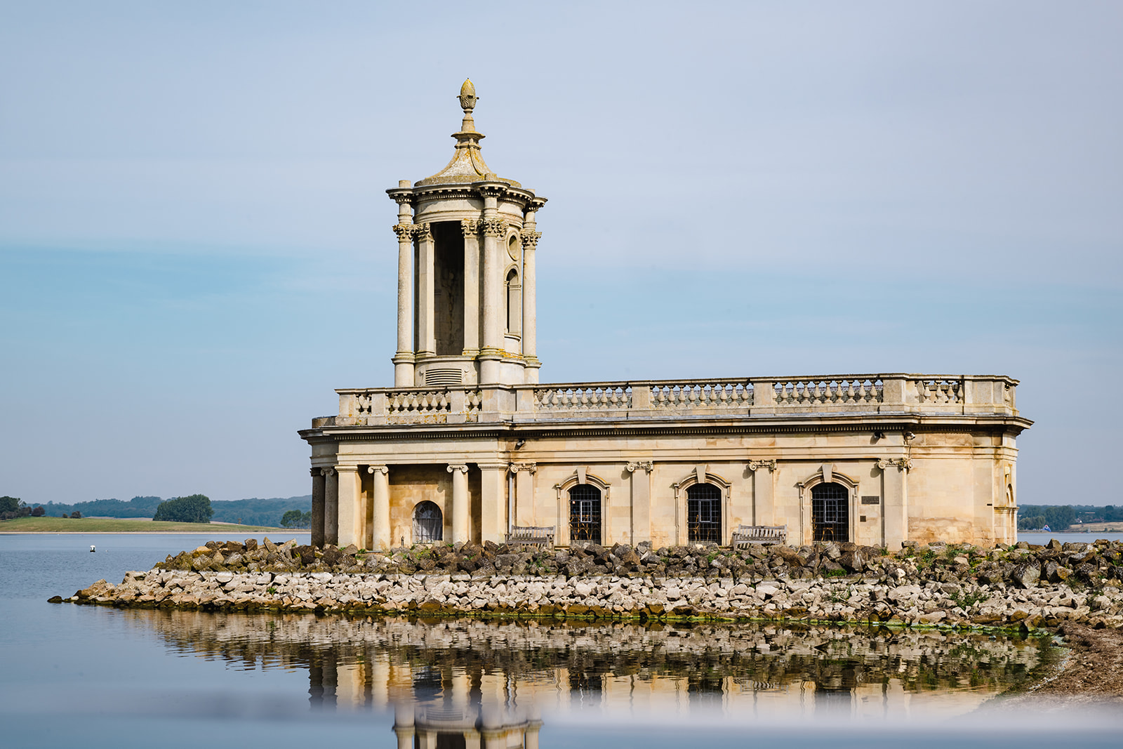 wedding couple posing for a portrait at Normanton Church on Rutland Water