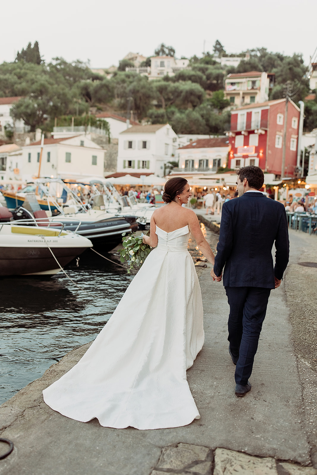 Couple walk to wedding in Paxos Greece