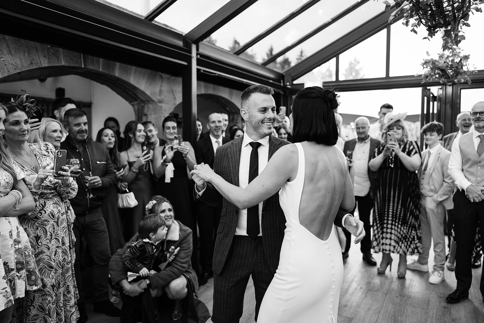 black and white wedding photo of the couple doing their first dance at the hovels