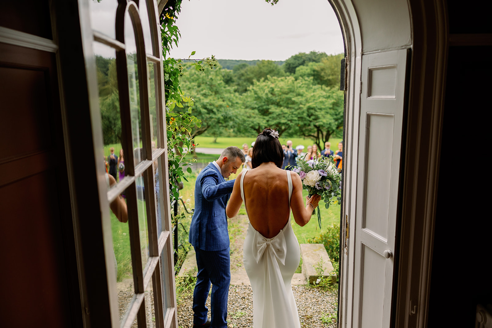 Bride and groom entering their drinks reception at Harewood House