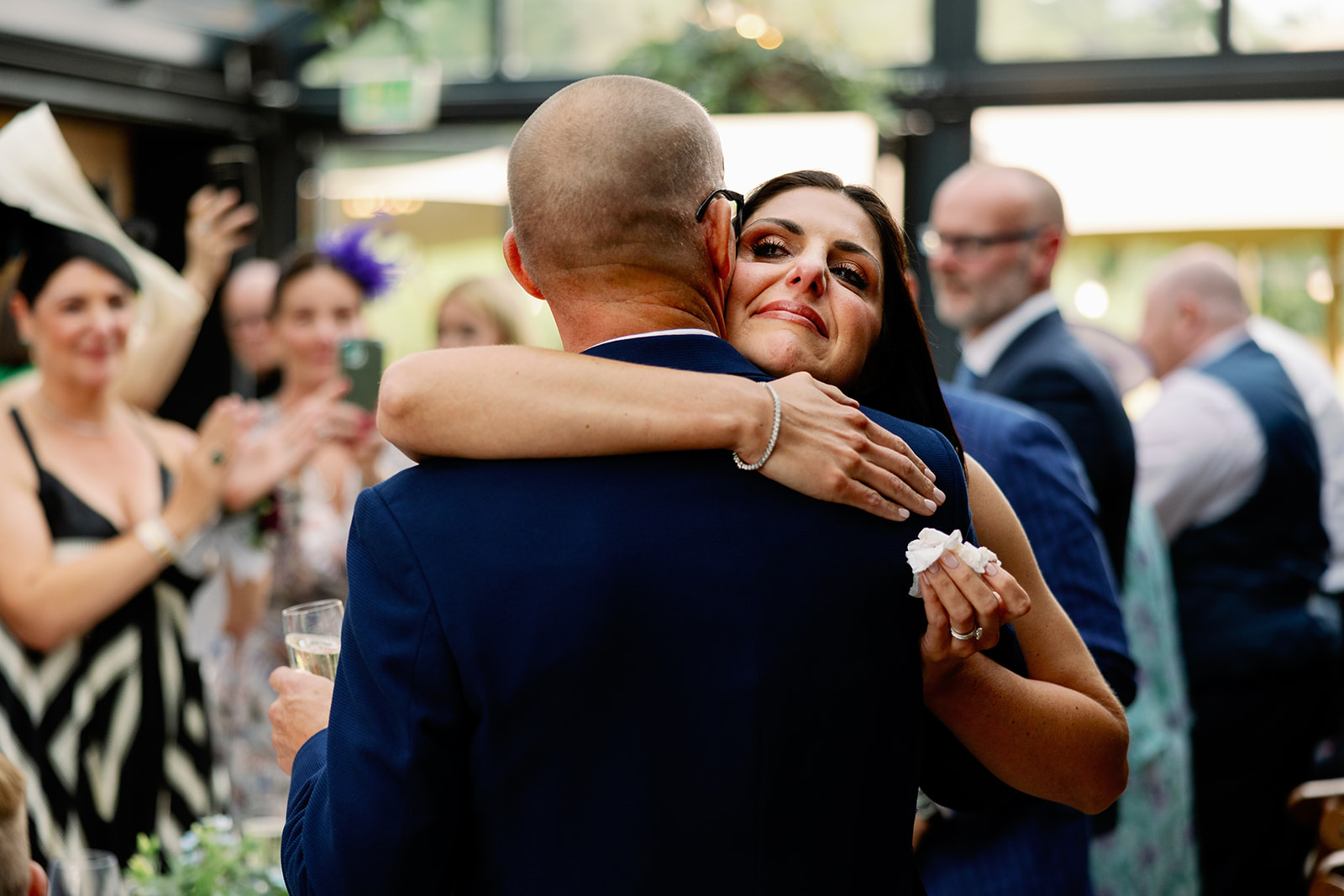 bride hugging her dad after he finished his wedding speech