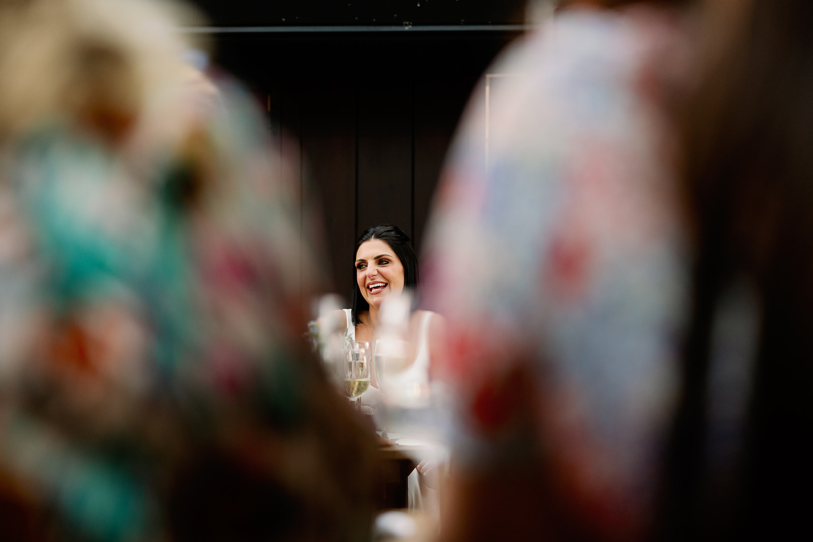 bride laughing during wedding speeches