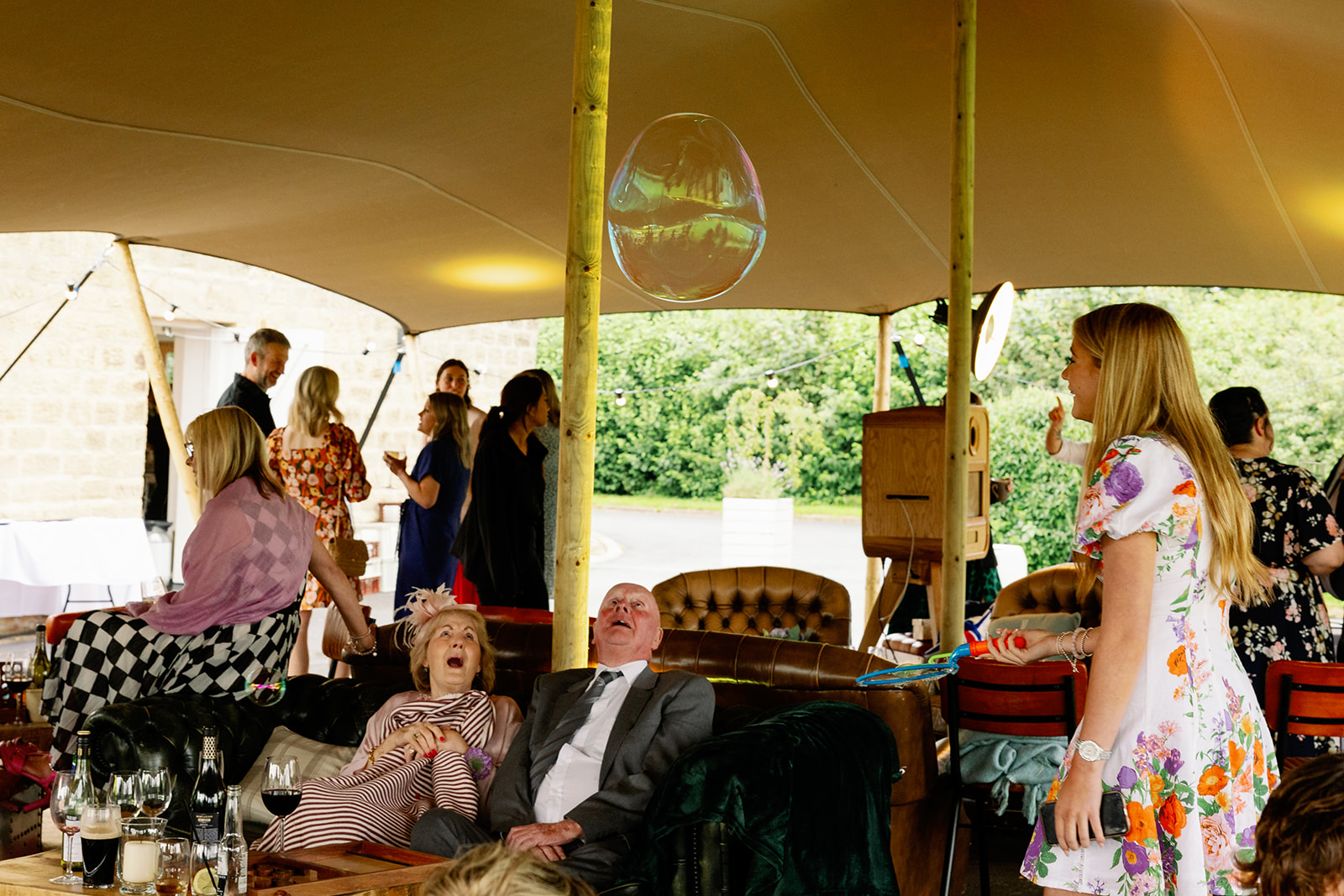 a huge bubble floating across a wedding reception