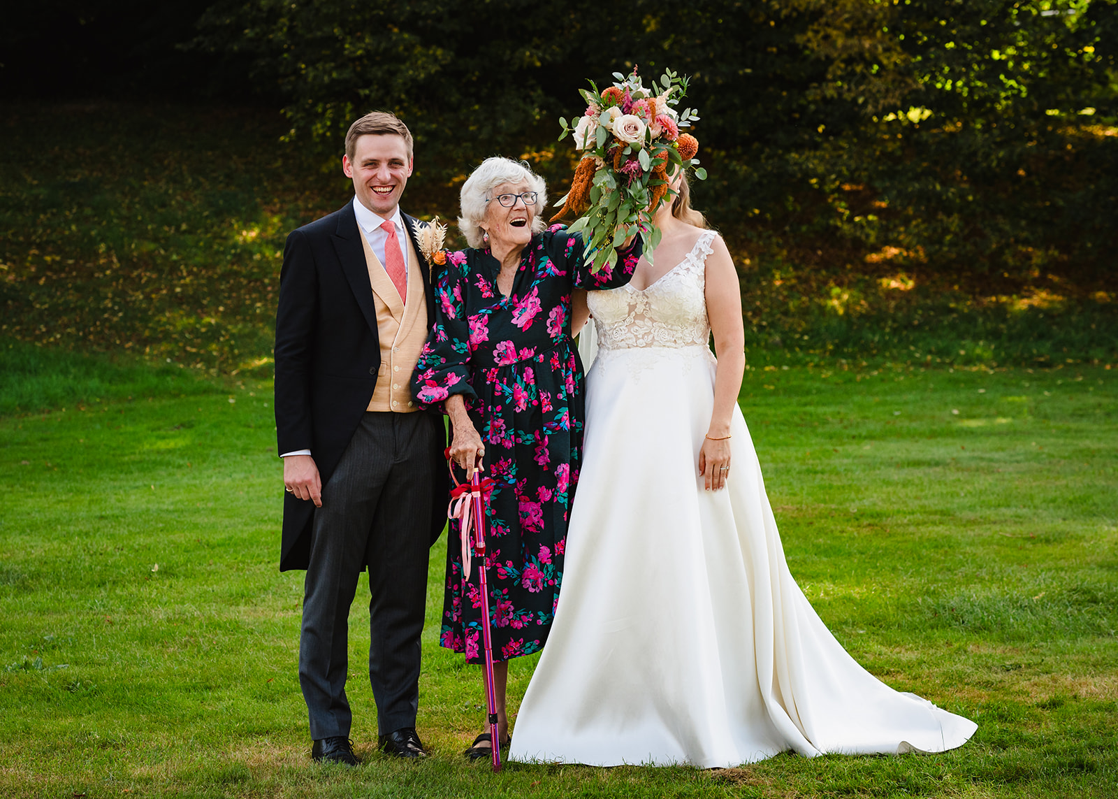 bride and groom pose with grandma at exton park