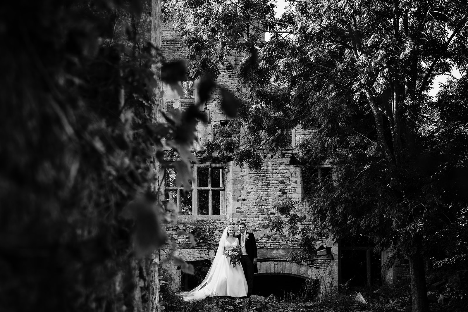 bride and grooms in the ruins at exton park rutland