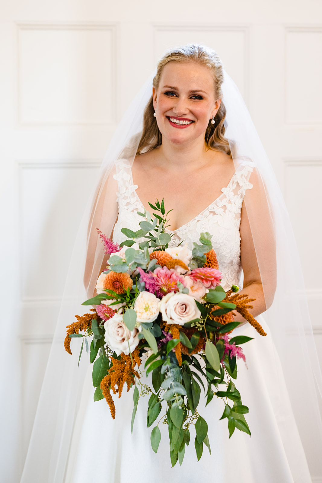 stunning bride posing with her wild bouquet 