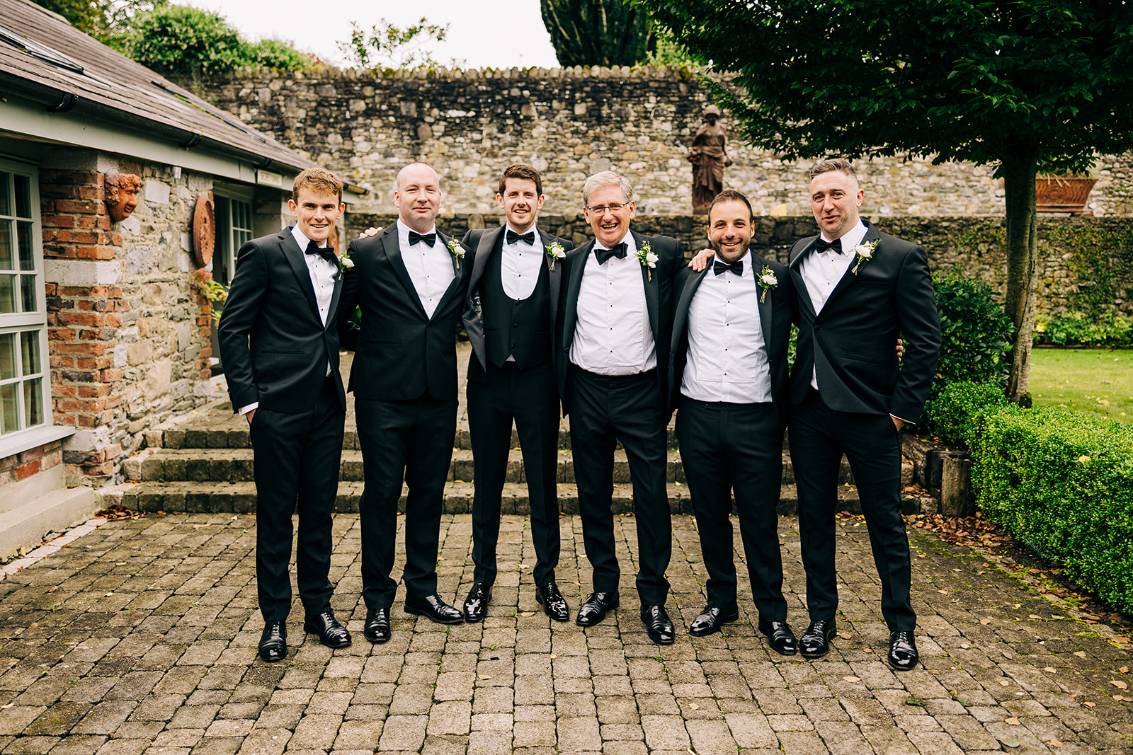 groom and groomsmen pose for pictures in tankardstown house 