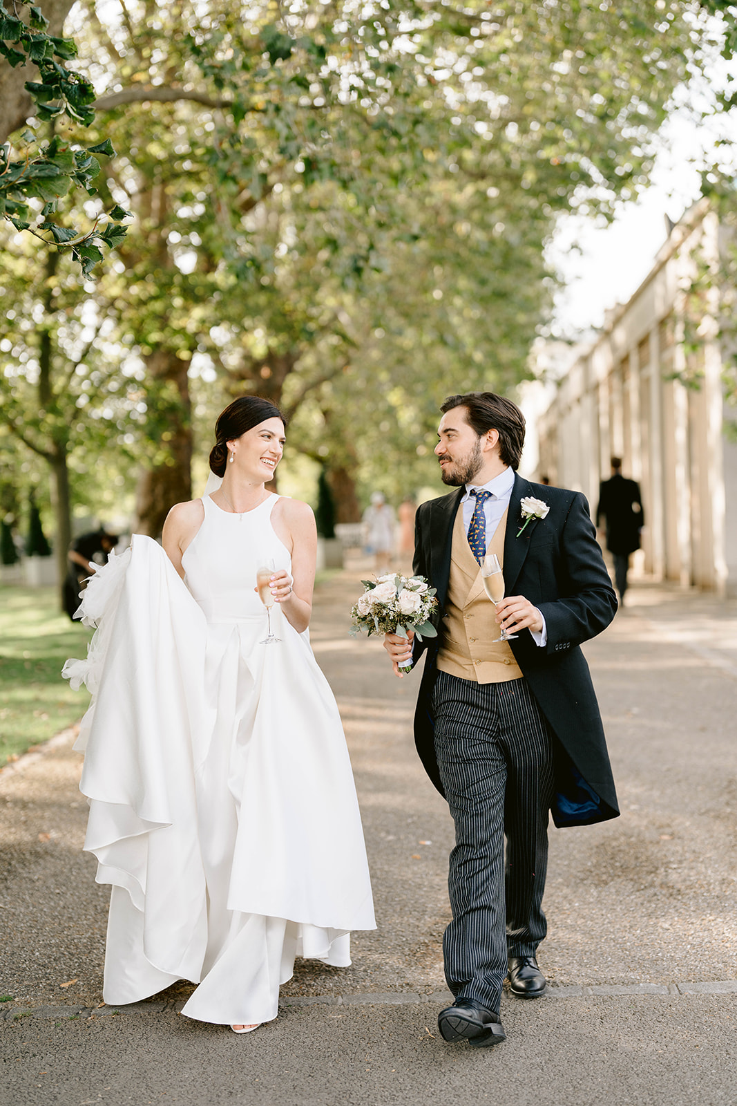bride and groom walking together at the hurlingham club london