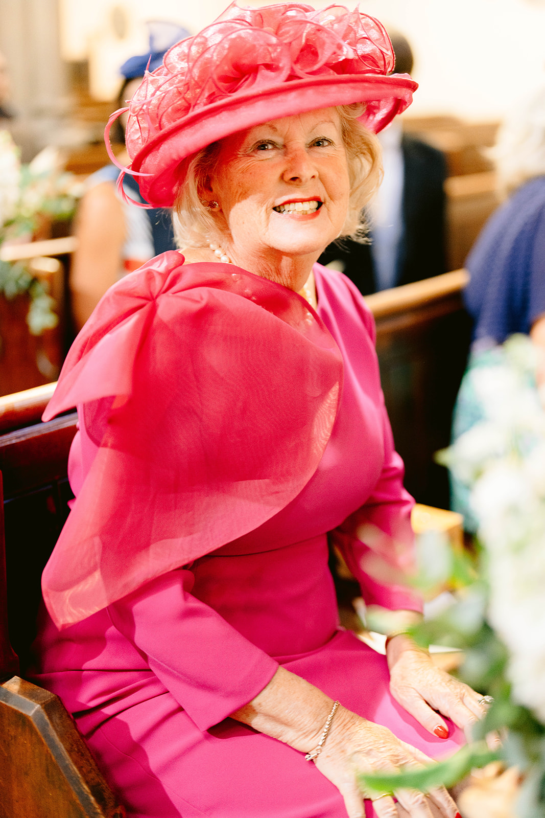 a glamorous wedding guest in pink