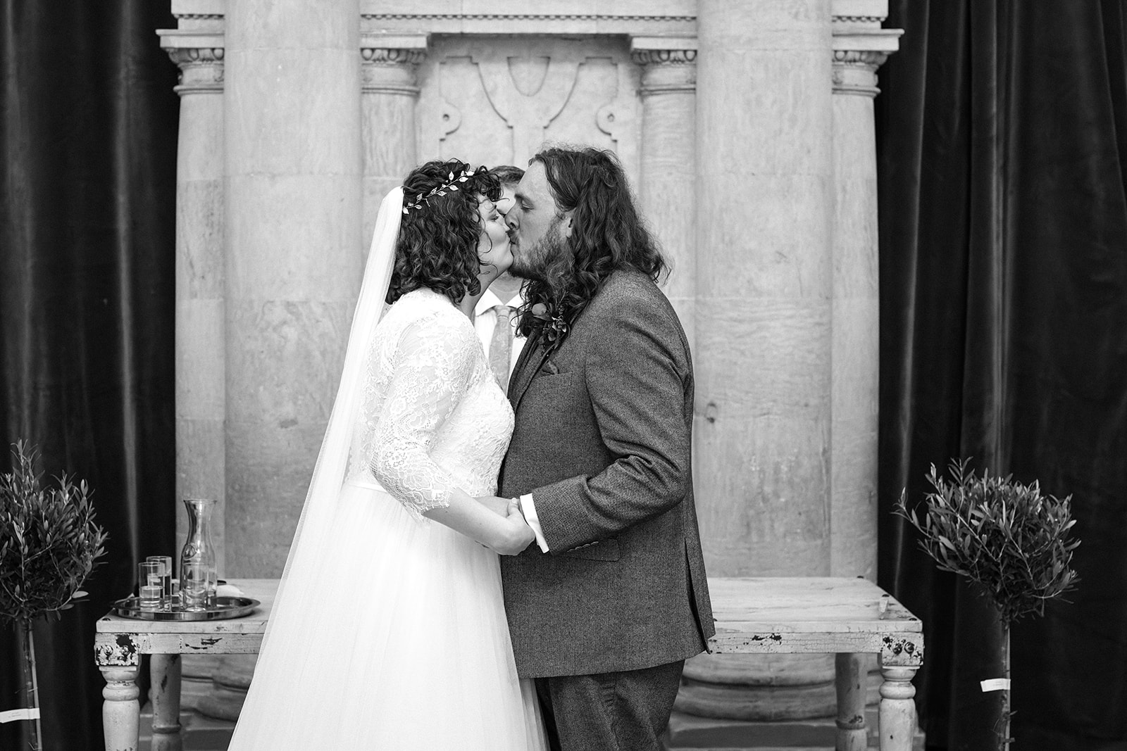 The bride and groom kiss after their wedding ceremony at Wollaton Hall