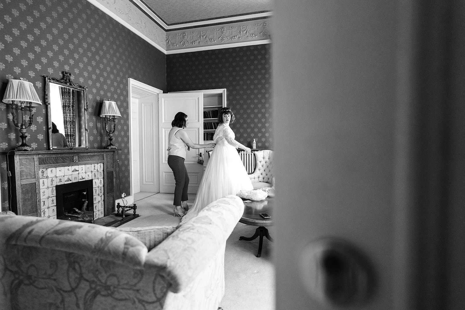 Wollaton Hall Wedding Photography - bride getting into her wedding dress on the morning of her wedding