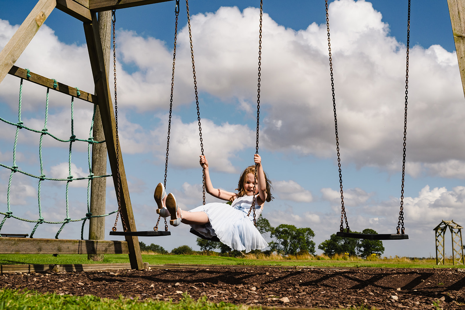 girl swinging on swings at the barnsdale