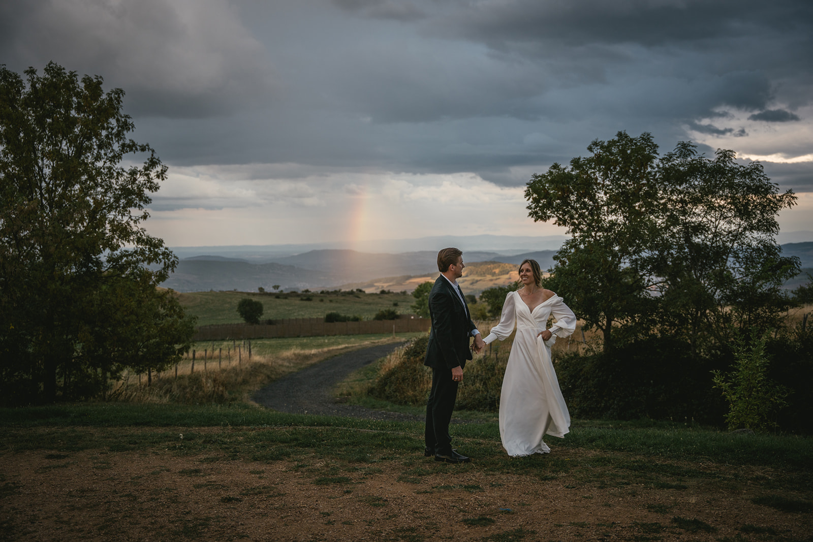 Couple dancing with a rainbow on their central France elopement