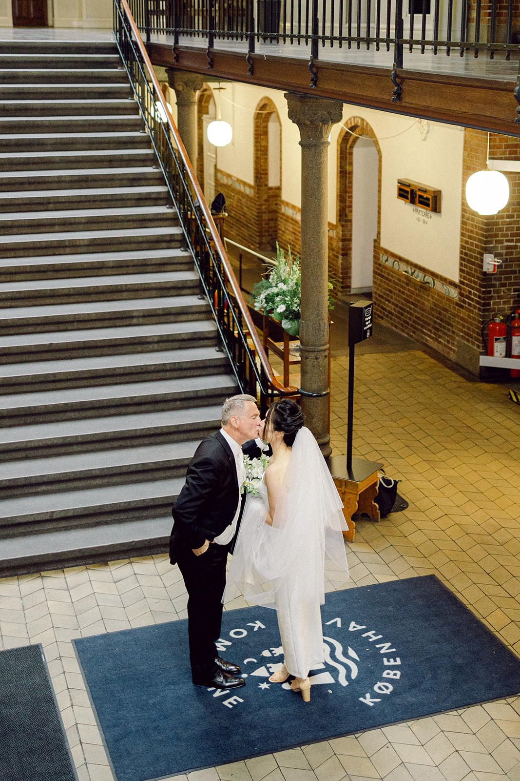 Bride and groom walking to copenhagen city hall to get married in denmark