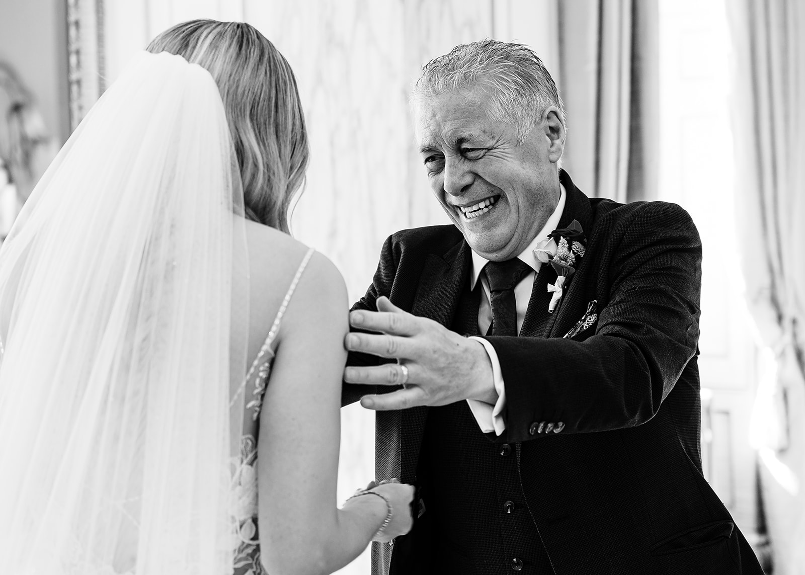 An emotional moment as the father of the bride reaches out to hug his daughter