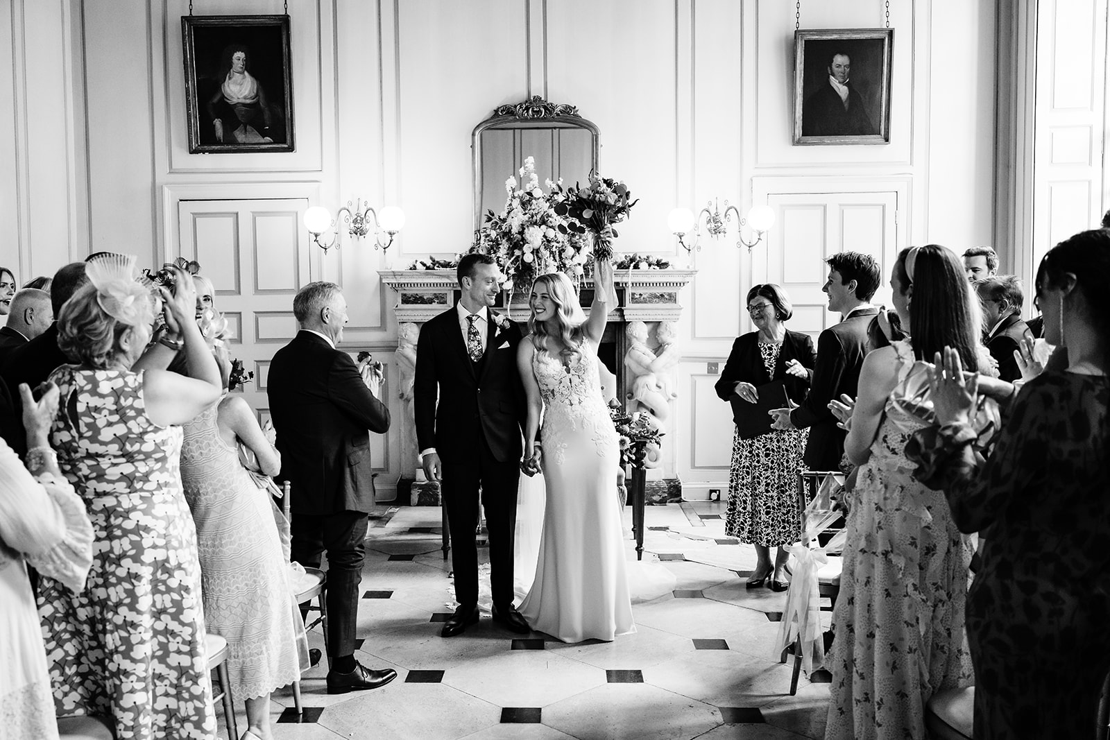 Bride and groom walking back down the aisle at the grand salon