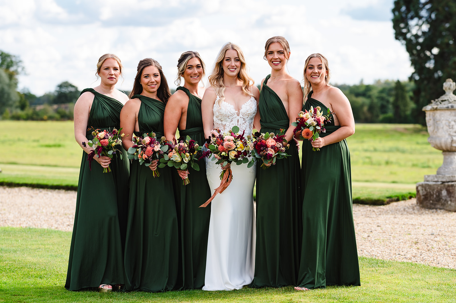 Bride and her bridesmaids in the grounds of gosfield hall
