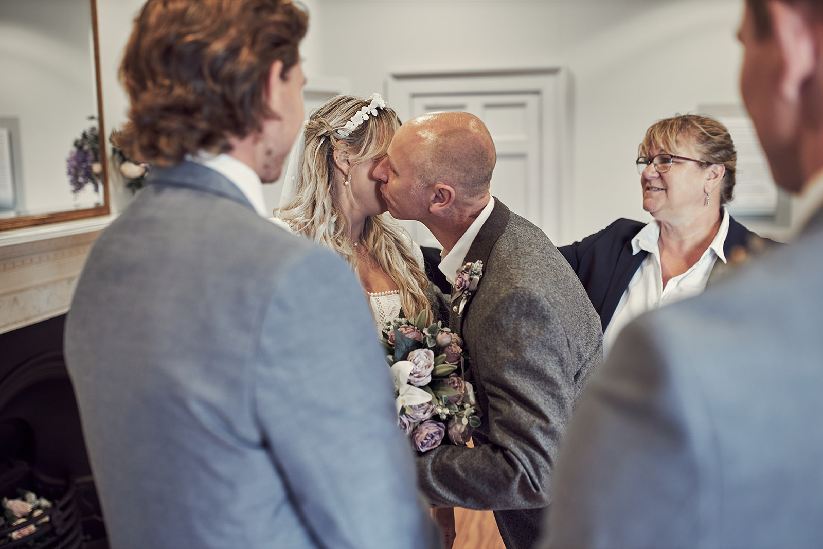father kisses bride before heading to his seat