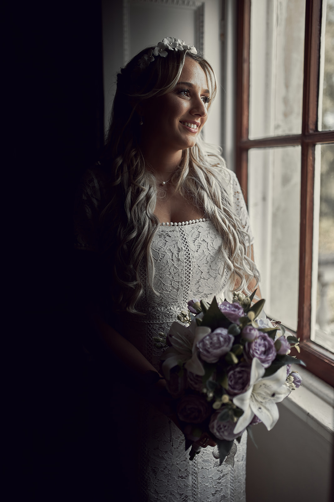 portrait of bride looking outside the window