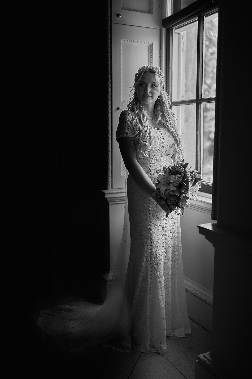 portrait of bride standing by the window