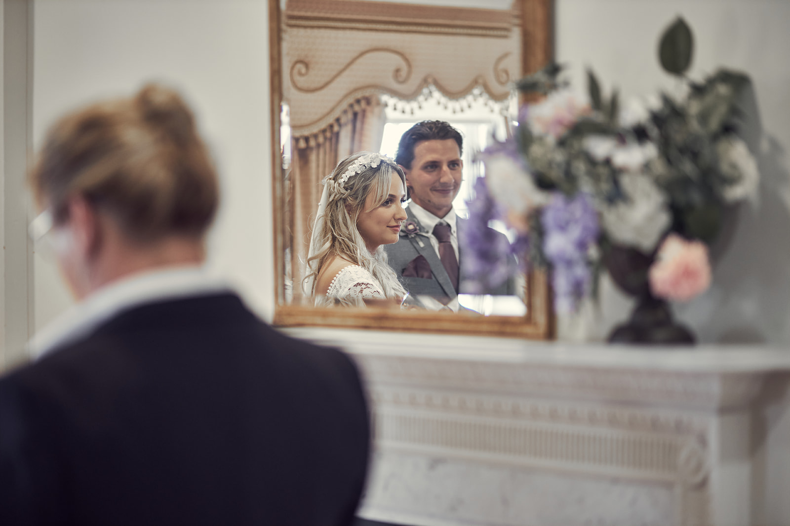 reflection of bride and groom looking good through the mirror at Danson house