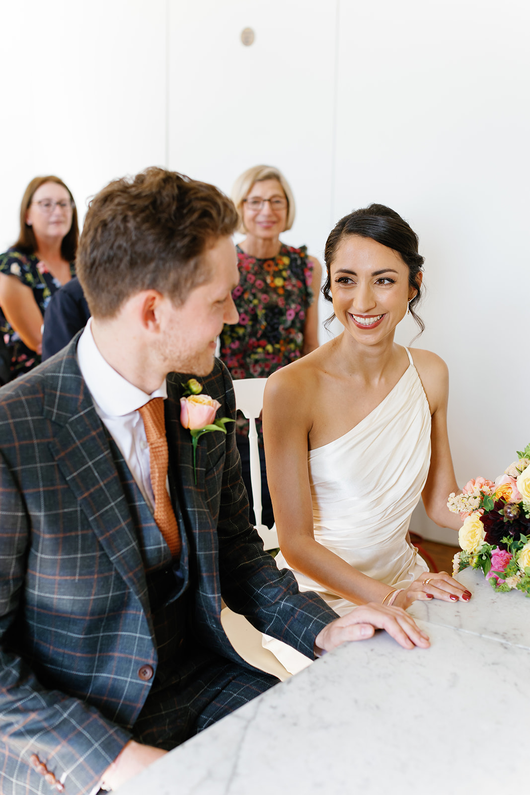 bride stares at groom with a smile