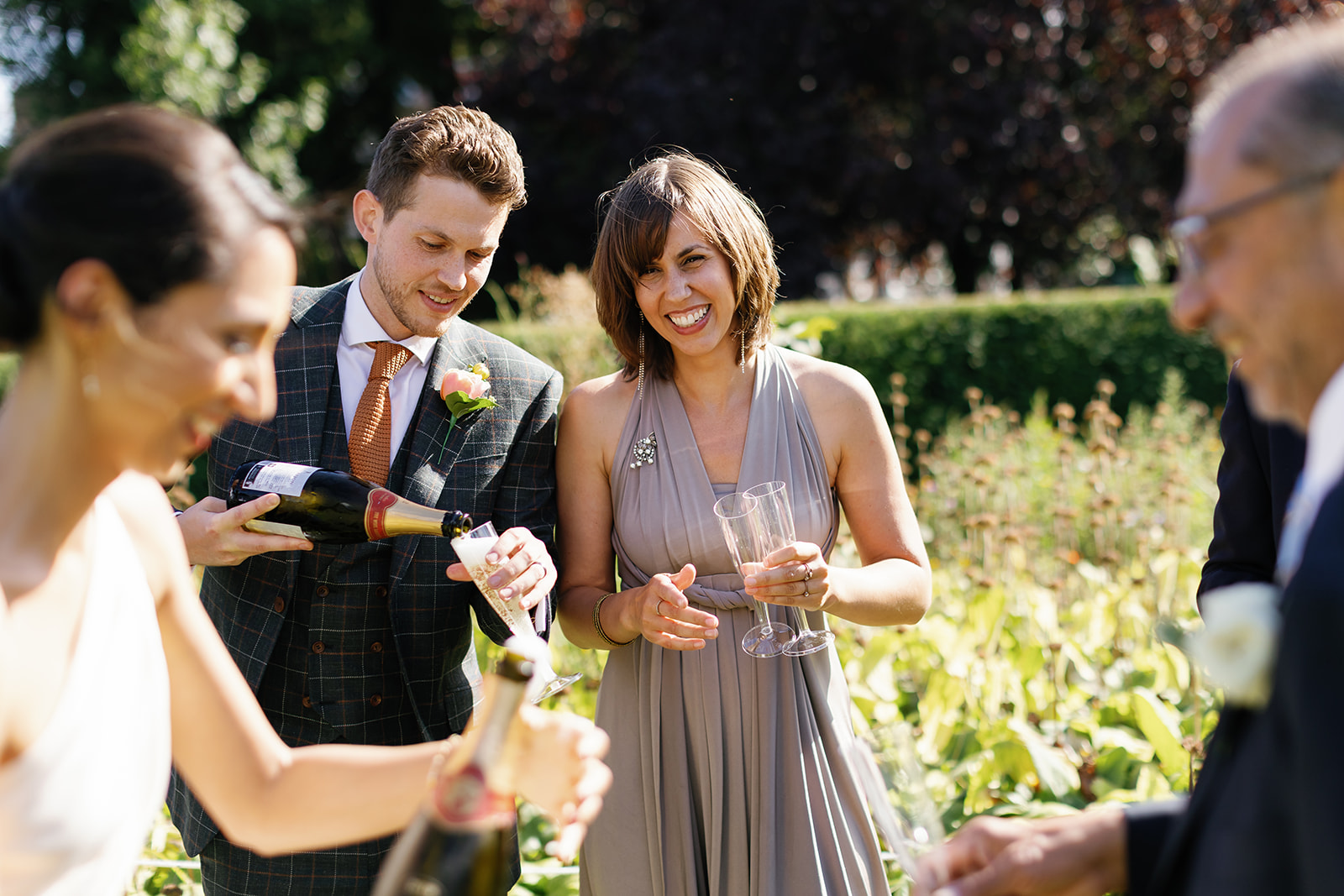 groom pouring wine for the guests