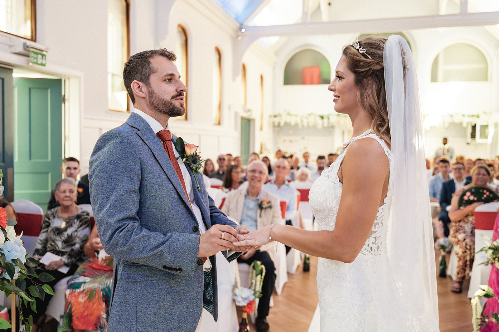 Natalie and George's ring exchange during the wedding ceremony at Ashburton Hall