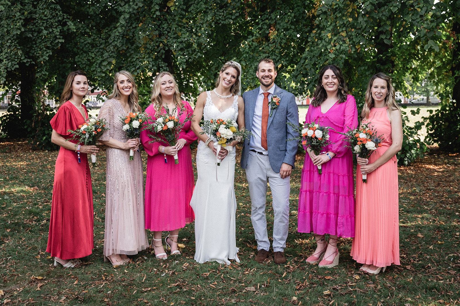 Portrait of Natalie and George with the bride's maids at Ashburton Hall