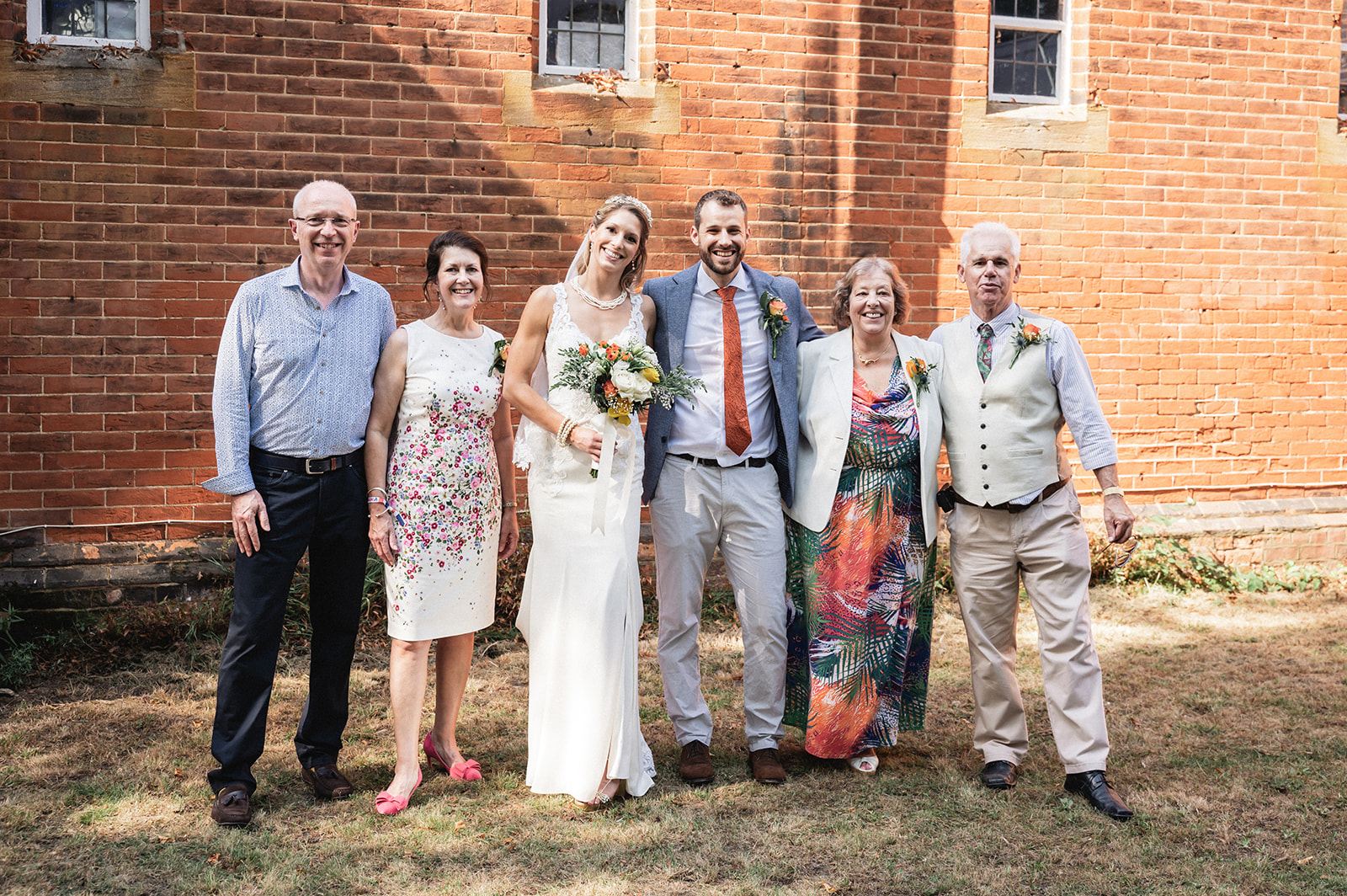 Portrait of Natalie and George with the parents at Ashburton Hall