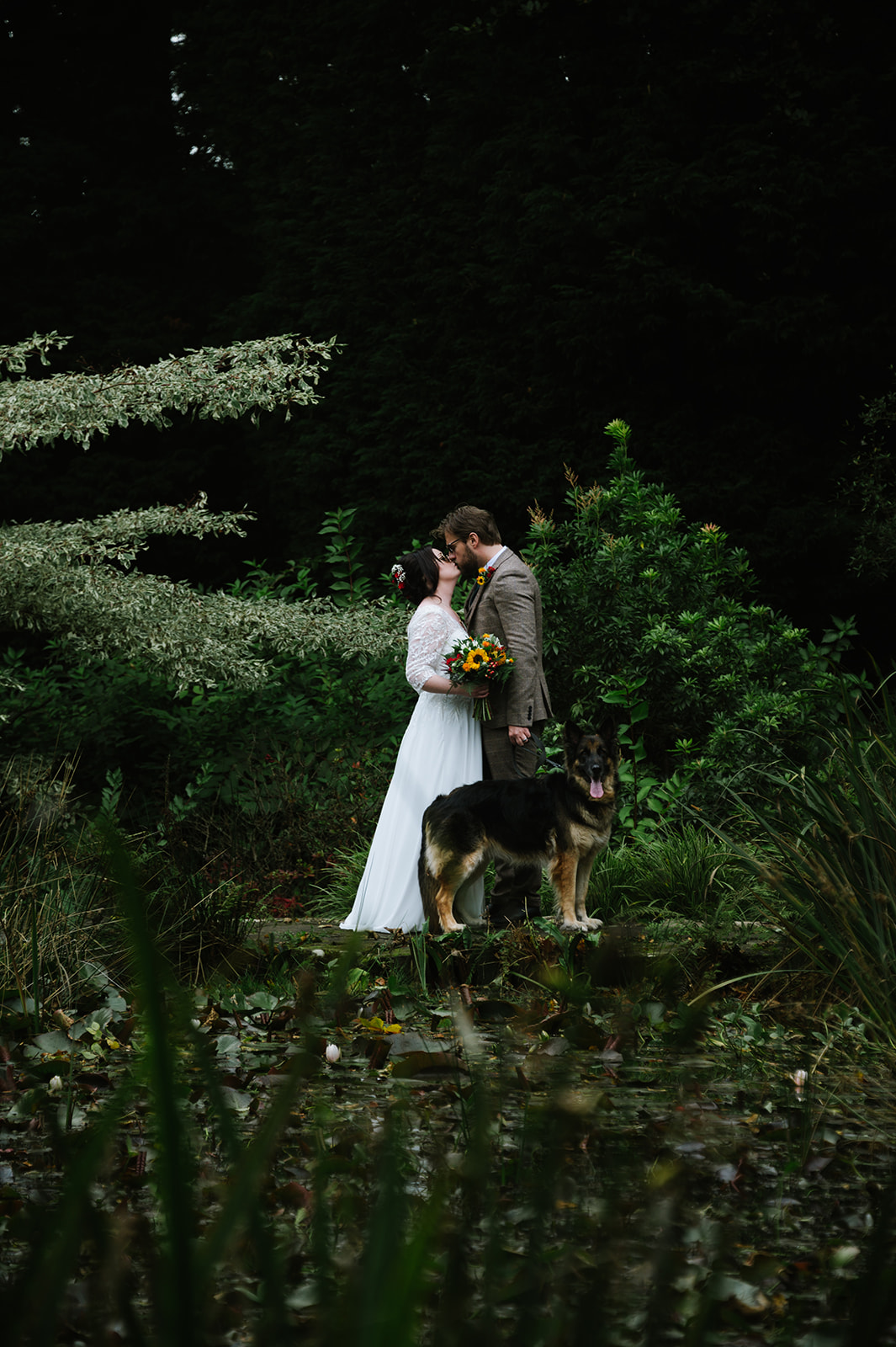The bride and groom at their Whirlowbrook Hall wedding in Sheffield, with their dog.