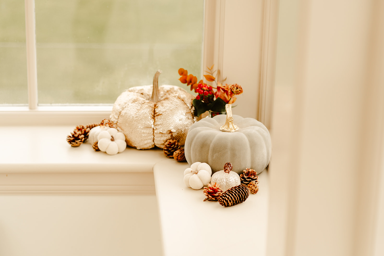 autumn pumpkin decorations on window sill